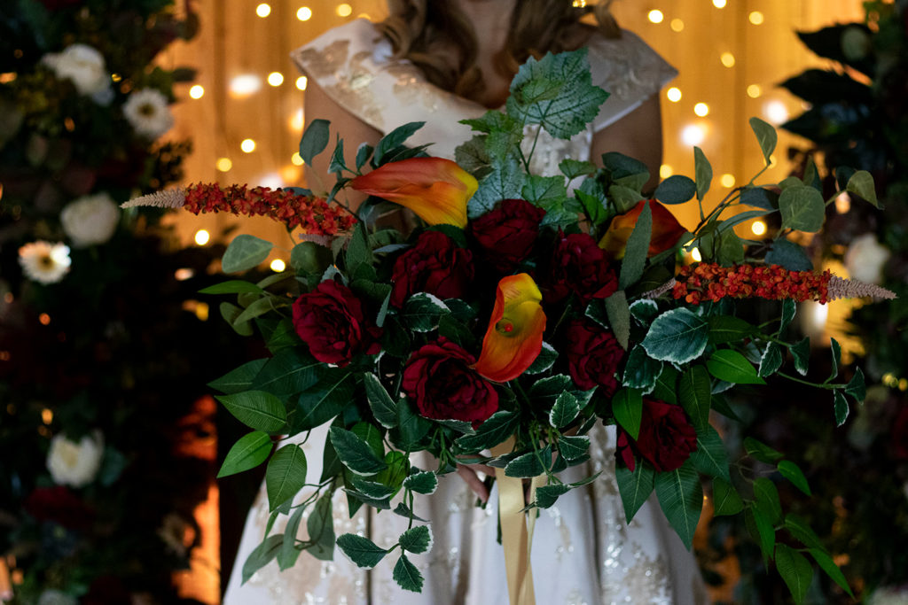 Image of autumn bridal bouquet with deep red roses and orange calla lilies