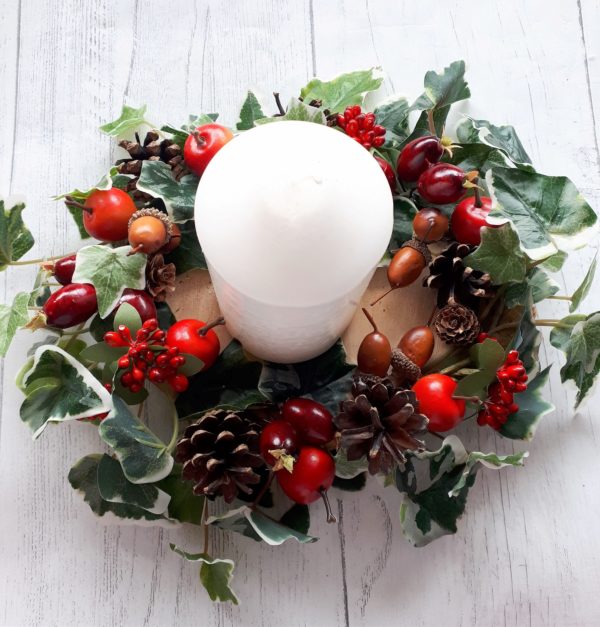 Ivy, berries and fruit tablecentre with pillar candle