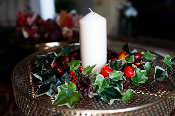 Image of table centre with faux berries and variegated ivy