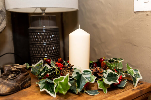 Image of table centre with faux berries and variegated ivy