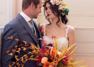 Photo of wedding couple with boho autumn bouquet