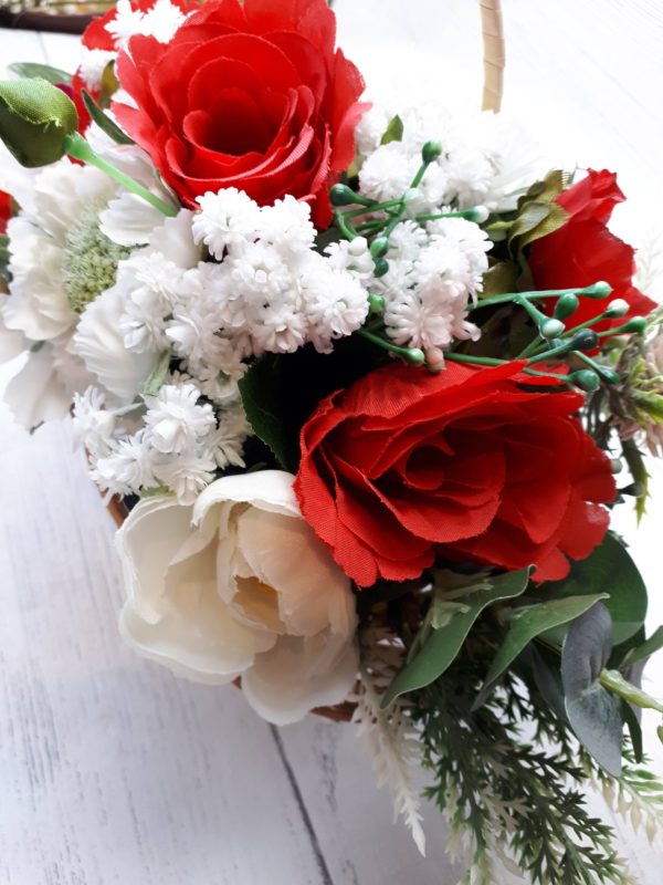 Close up of red silk roses and faux white gypsophila