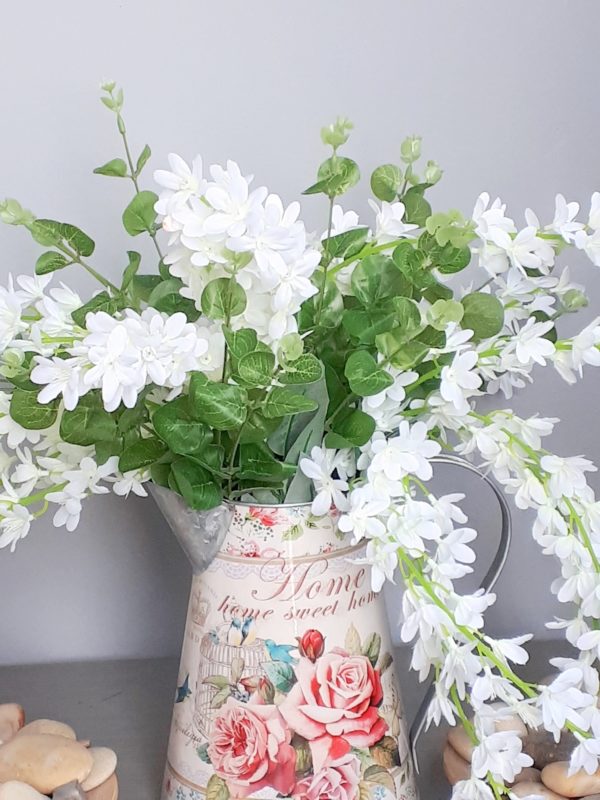 image of white trailing wisteria in a jug