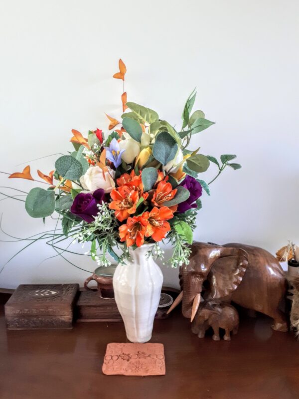 White ceramic vase with bouquet