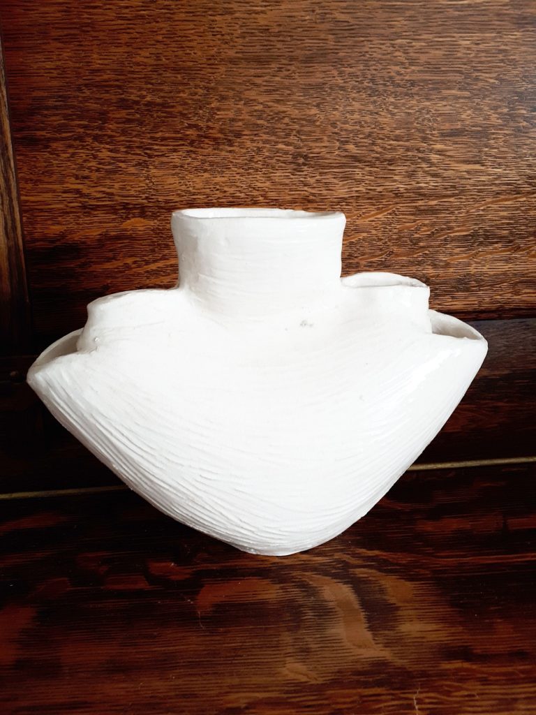 white ceramic vase with peonies