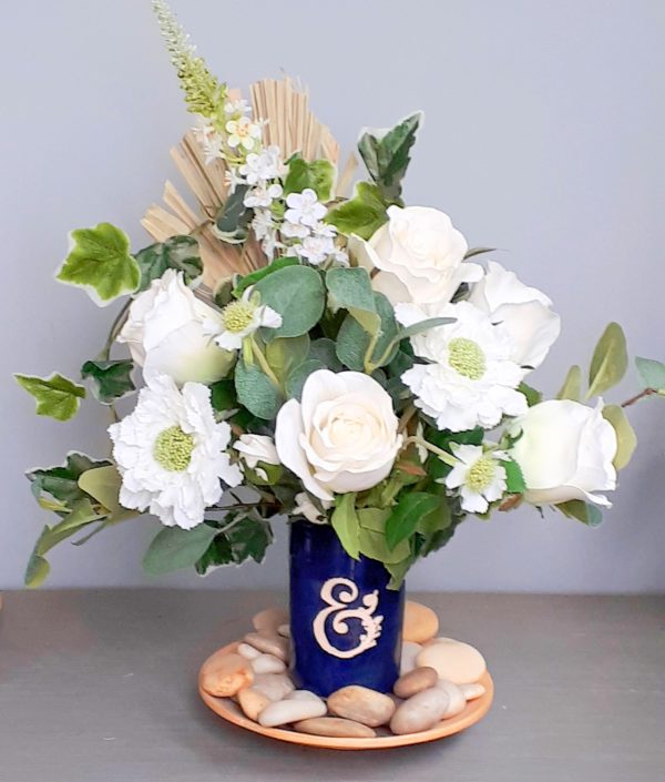 BLue vase with white and green flowers