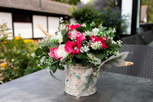 Windflower anemone table centre with pink and cream flowers on an outside table