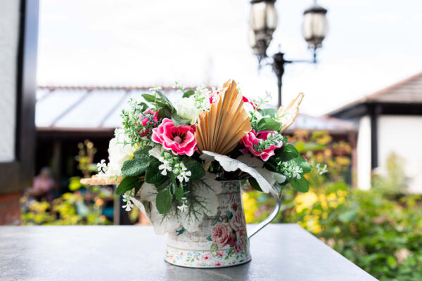 Windflower anemone table centre with pink and cream flowers on an outside table