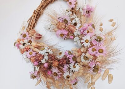 Heart shaped wreath with dried grasses and pink and white dried flowers