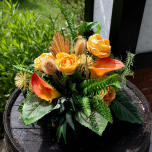 Sunshine Glow Tabble centre with orange calla lilies and orange roses