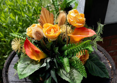 Sunshine Glow Tabble centre with orange calla lilies and orange roses