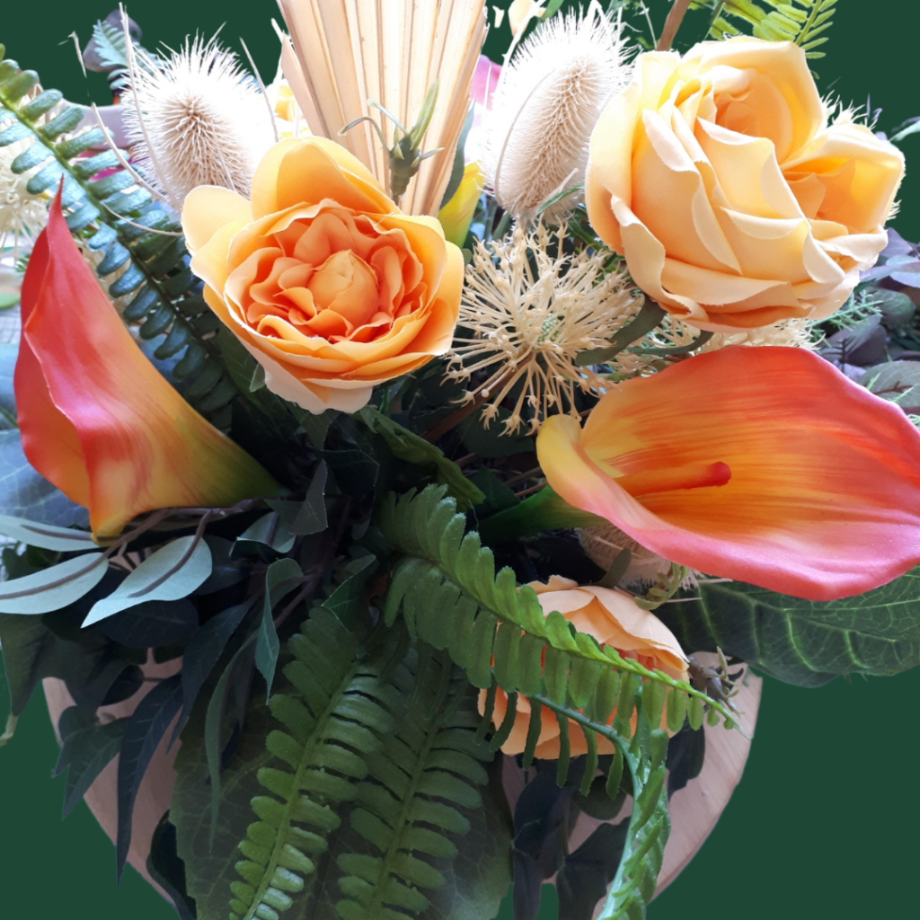 Image of summer table centre with orange and yellow faux flowers