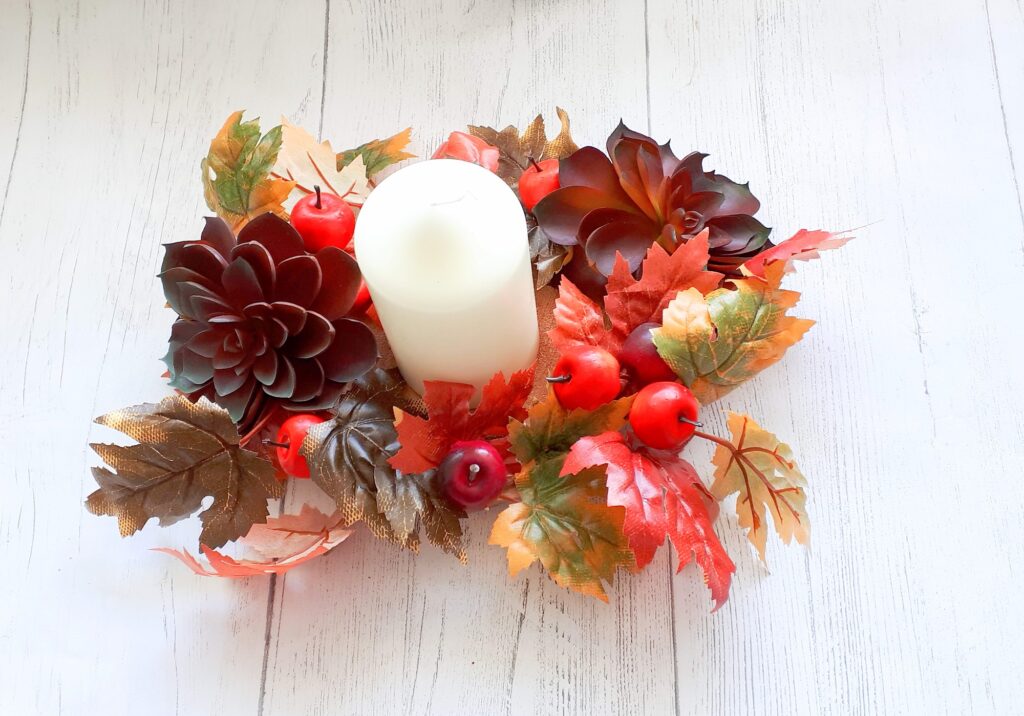 Image of autumn table centre with faux burgundy succulents