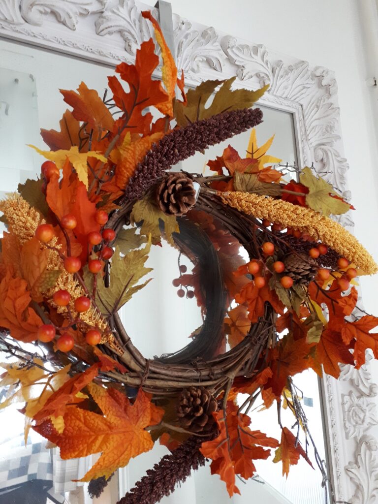 Autumn golds in an autumn wreath of faux ivy and oak leaves, with natural pinecones