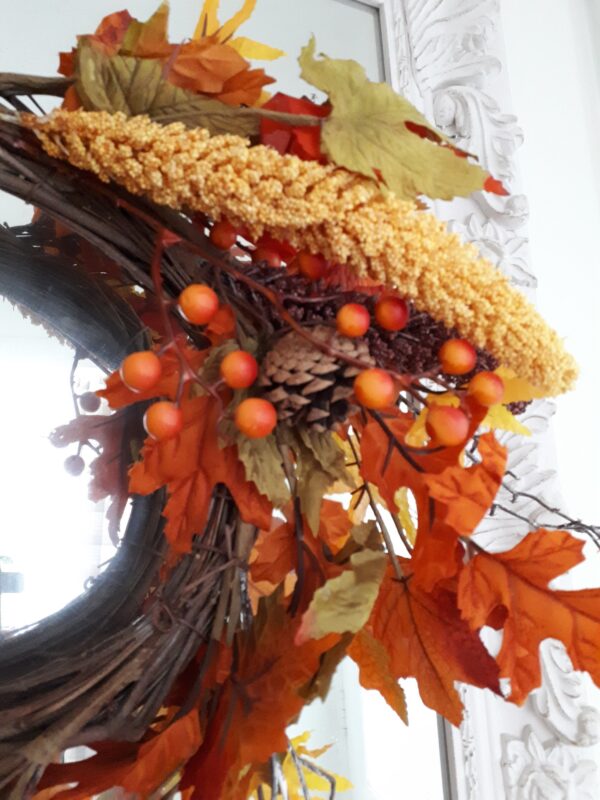 Autumn golds in an autumn wreath of faux ivy and oak leaves, with natural pinecones