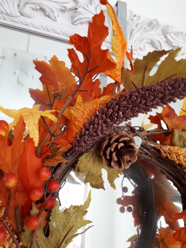 Autumn golds in an autumn wreath of faux ivy and oak leaves, with natural pinecones