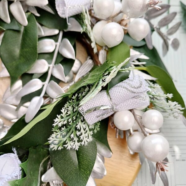 Closeup detal of silver and white decorations on a festive table centre