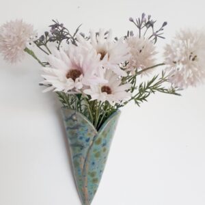 Image of ceramic bud vase for wall hanging with faux flowers