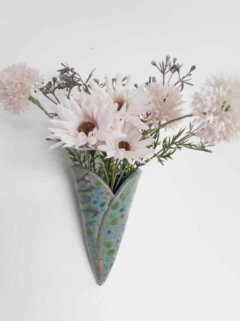 Image of ceramic bud vase for wall hanging with faux flowers
