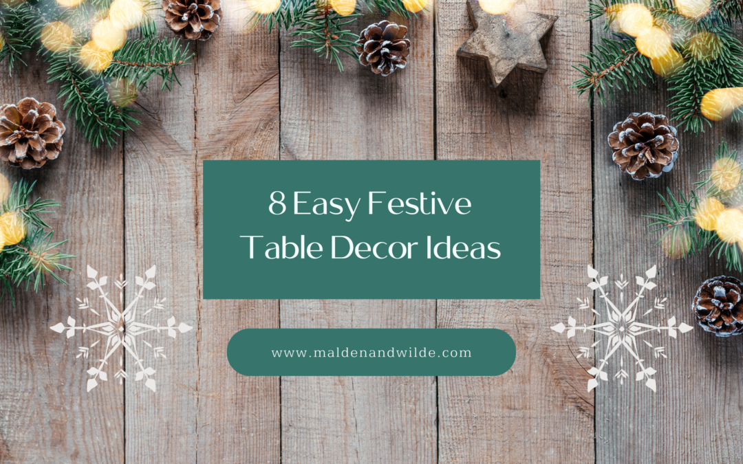 Image of wooden table with pinecones, pine branches and lights, title 8 easy festive table decor ideas