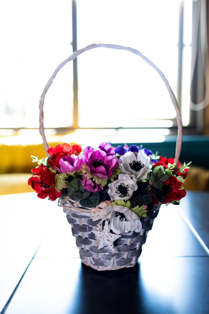 Basket of summer flowers in red, pink, mauve and white