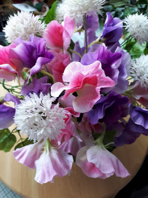 Image of pink and mauve sweet peas with pale pink fau alliums