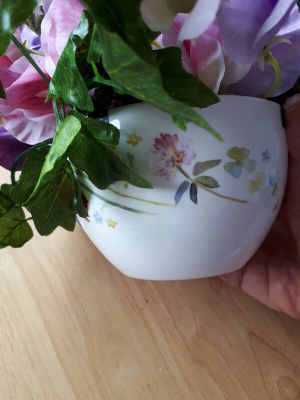 Image of a teacup painted with pretty dainty meadow flowers