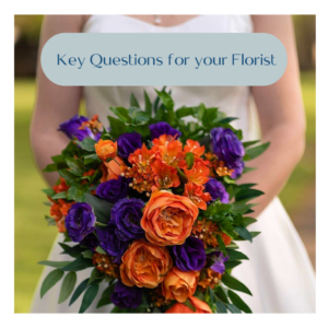 Image of bride holding her bridal bouquet. The flowers are orange silk roses, purple silk lysianthus and deep green silk foliage
