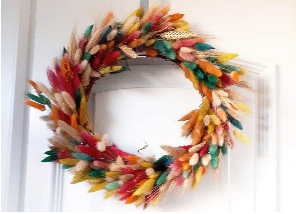 Multi coloured dried grasses in a colourful wreath