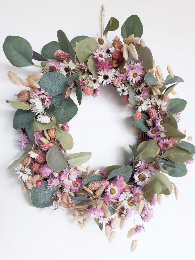 Image of wreath with pink and white everlasting flowers, natural quaking grasses and green eucalyptus