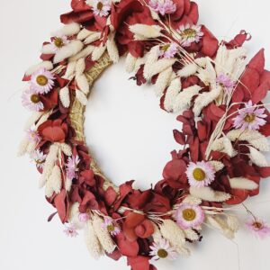 Red eucalyptus wreath with dainty pink dried flowers and bleached grasses