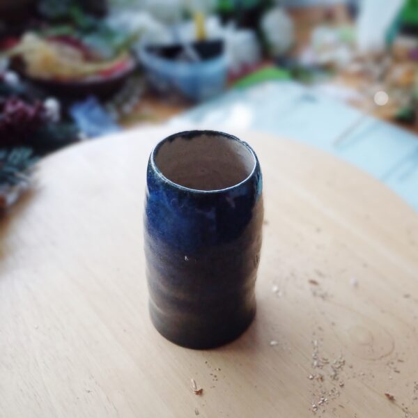 Image of plain ceramic bud vase with deep blue glaze