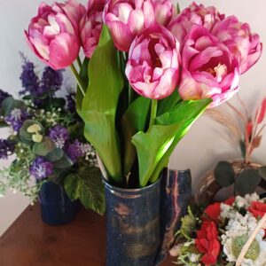 Purple variegated tulips in a deep blue ceramic vase