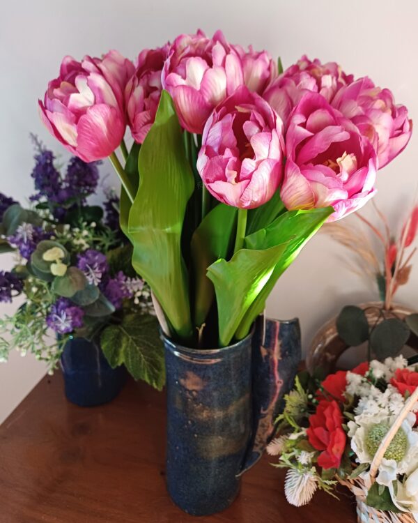 Purple variegated tulips in a deep blue ceramic vase