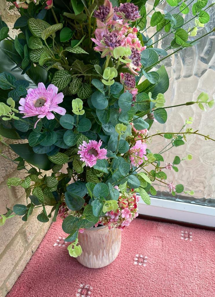 Flower pillar with pink and lilac flowers