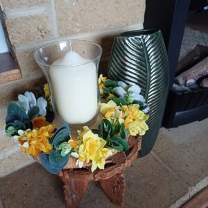 Image of spring flower table centre, with a magazine and cup of coffee.