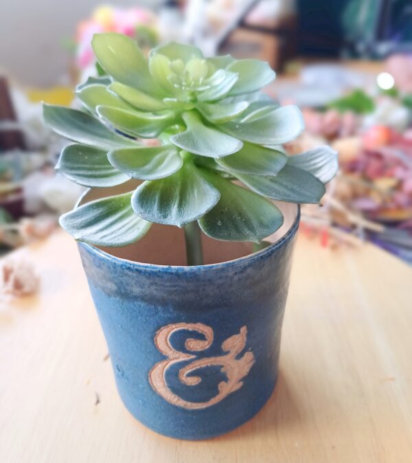 Image of electric blue ceramic vase with large faux succulent