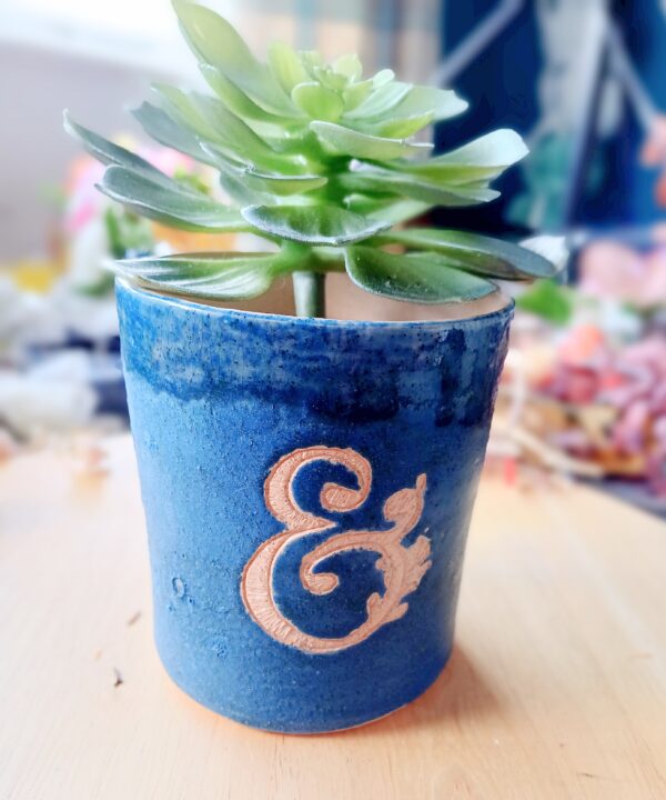 Electric blue ceramic vase with ampersand engraved into the glaze