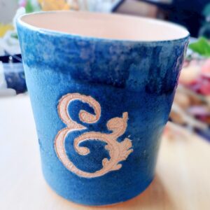 Electric blue ceramic vase with ampersand engraved into the glaze