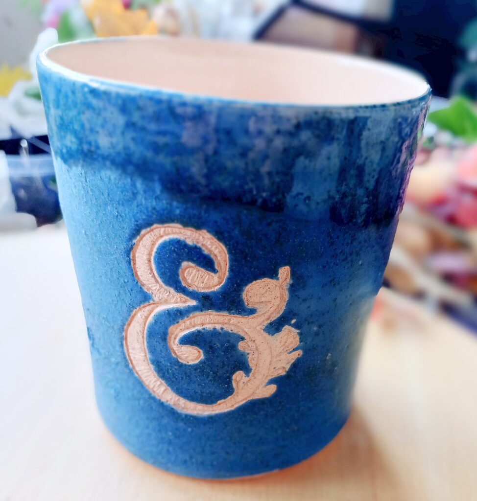 Electric blue ceramic vase with ampersand engraved into the glaze