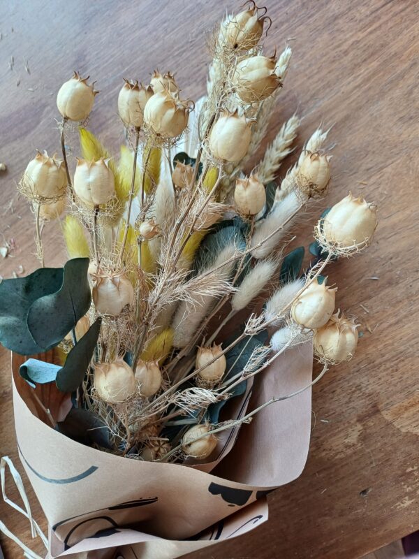 Image of dried grasses and flowers in yellow and neutral colours