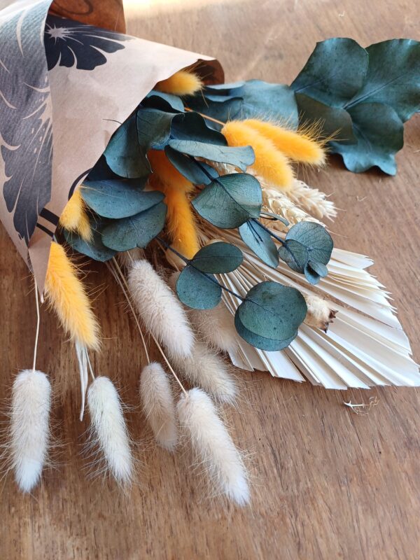 Image of dried grasses and flowers, blue, orange and neutral colours