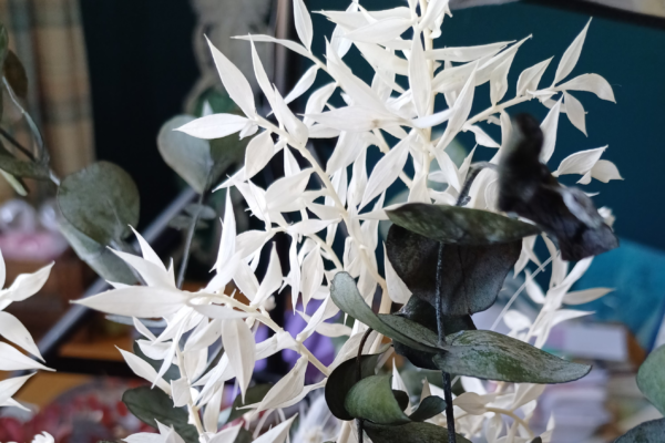 Detail of bleached dried ruscus foliage in pink and grey dried and preserved flower bouquet