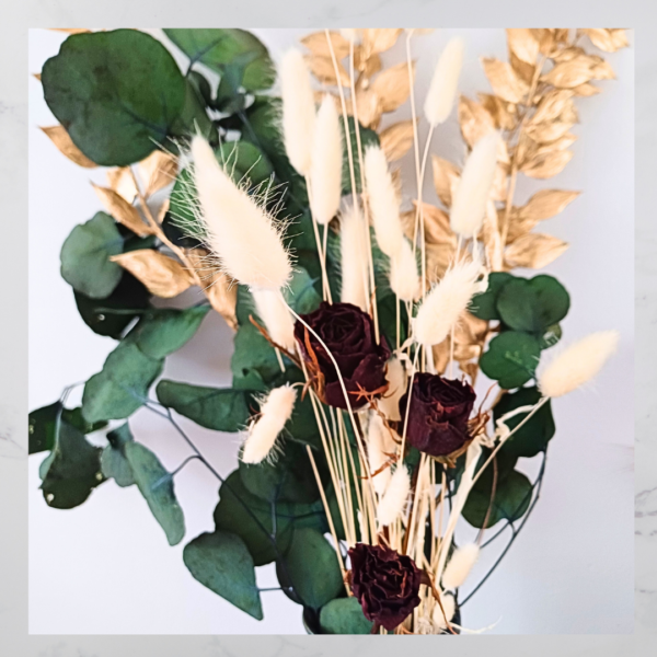 Image of deep red dried roses, and green and gold preserved foliage