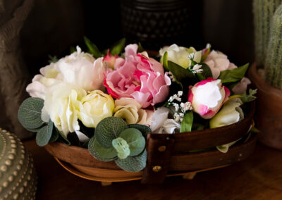 Image of wooden basket of pink and white silk peonies