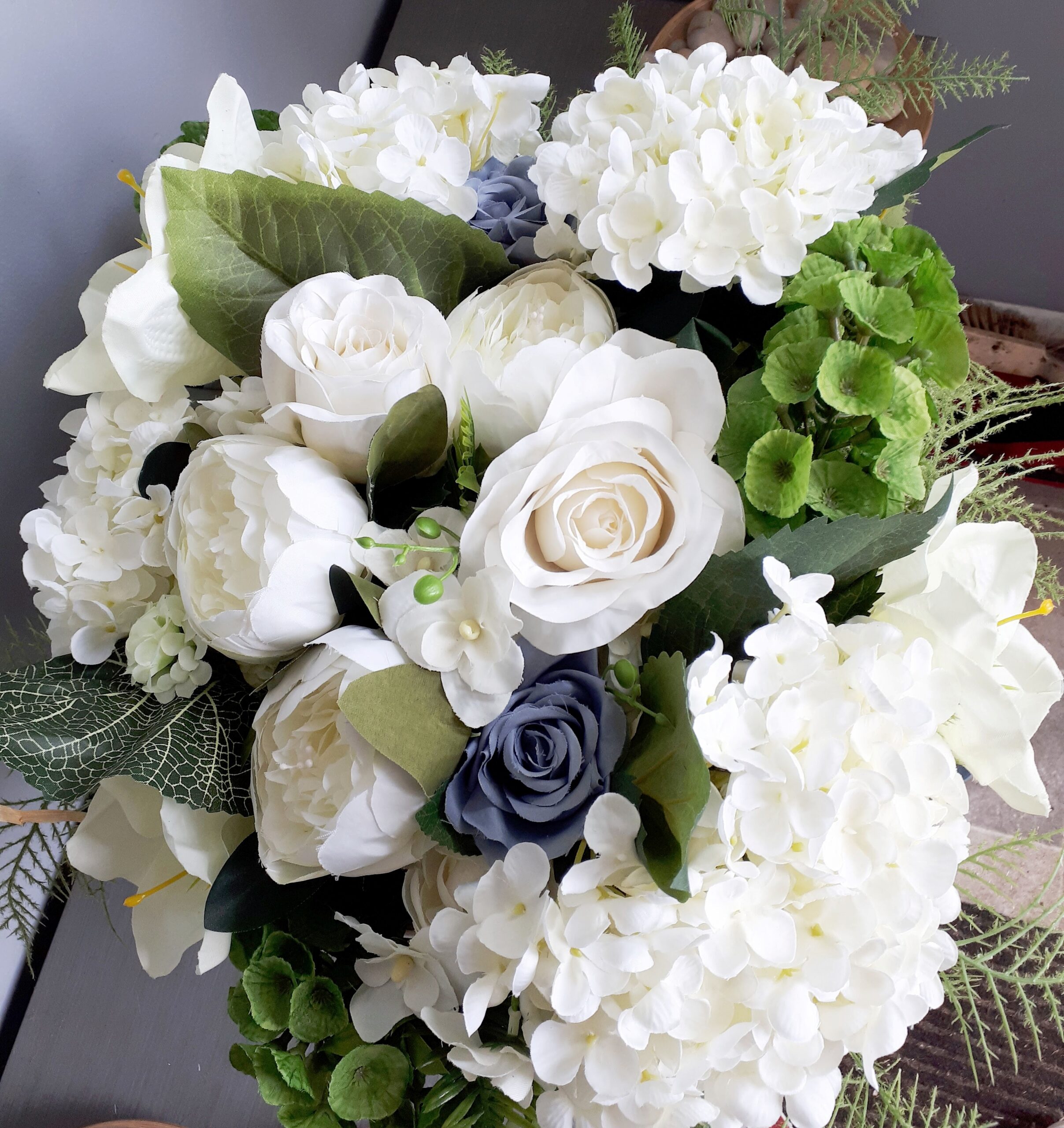 Imageof basket of white and blue flowers for a memorial tribute