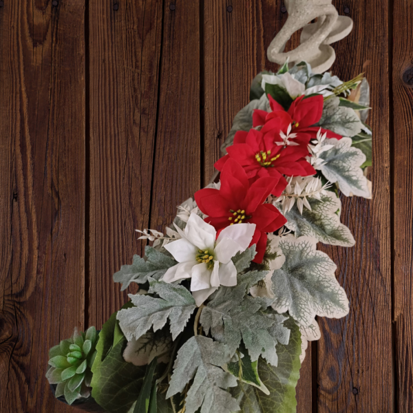 Red and white silk poinsettias, with silver and green foliage, for festive mantel arrangement