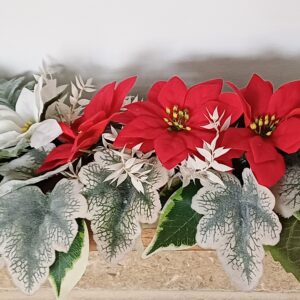 Red and white silk poinsettias, arranged with silver and green faux foliage, for a mantel piece decoration