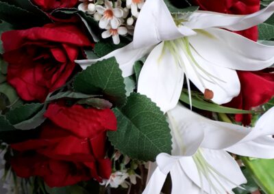 Image of white star lilies and red roses in a cascade bridal bouquet