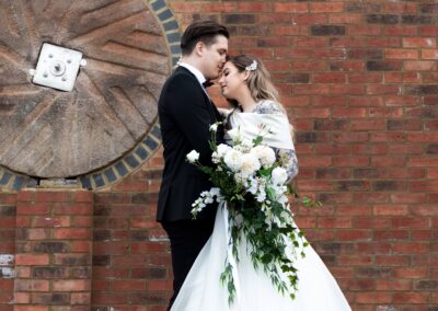 Image of wedding couple models, with a white cascade bouquet